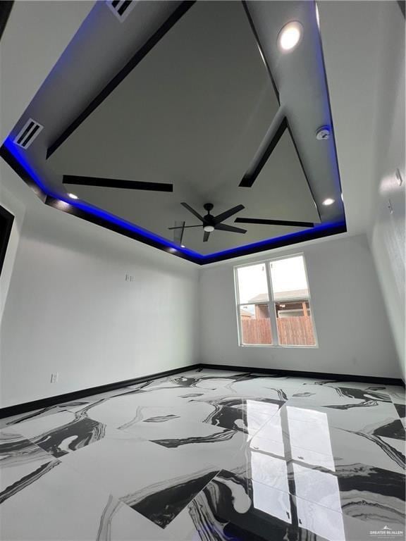 1505 W Kennedy Ave, Alton, TX 78573 - unfurnished room with a tray ceiling, baseboards, ceiling fan, recessed lighting, and marble finish flooring