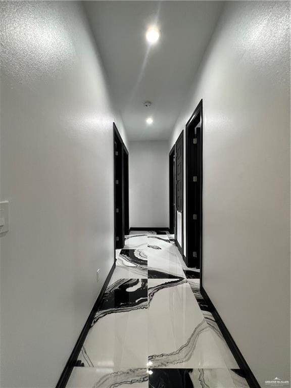 1505 W Kennedy Ave, Alton, TX 78573 - corridor with marble tiled flooring, baseboards, and recessed lighting