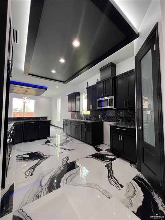 1505 W Kennedy Ave, Alton, TX 78573 - kitchen with stainless steel microwave, dark cabinets, healthy amount of natural light, and recessed lighting