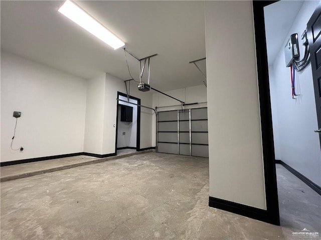 1505 W Kennedy Ave, Alton, TX 78573 - garage featuring baseboards and a garage door opener
