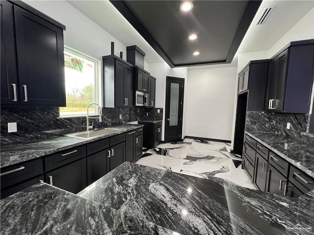 1505 W Kennedy Ave, Alton, TX 78573 - kitchen with a sink, stainless steel microwave, recessed lighting, dark stone countertops, and light marble finish flooring