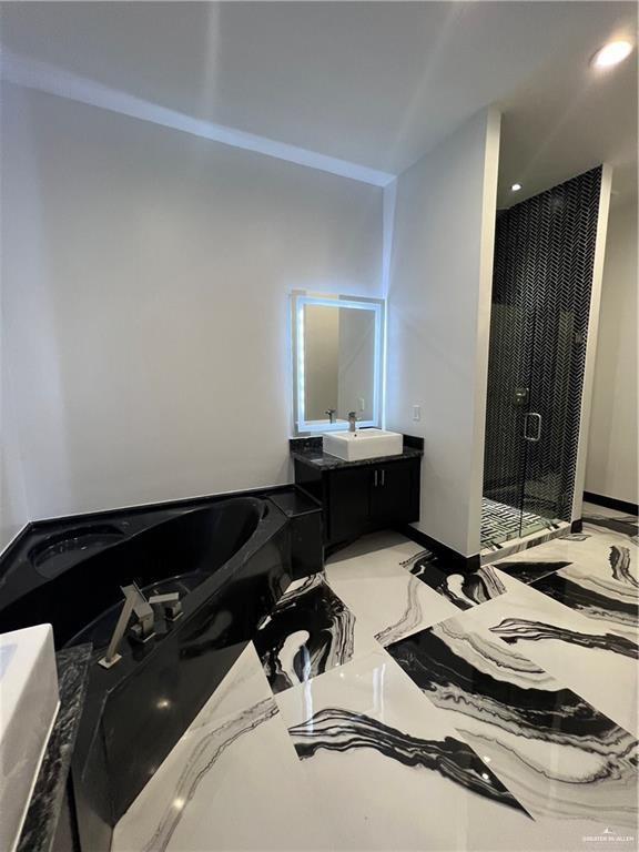 1505 W Kennedy Ave, Alton, TX 78573 - bathroom with a stall shower, a garden tub, vanity, and marble tiled flooring