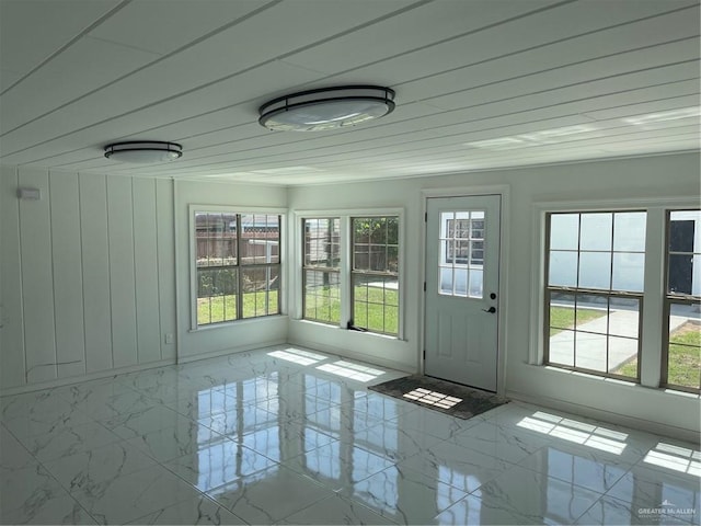 unfurnished sunroom featuring wooden ceiling