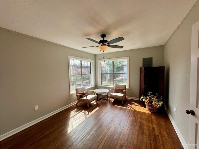 sitting room with ceiling fan, crown molding, and dark hardwood / wood-style floors