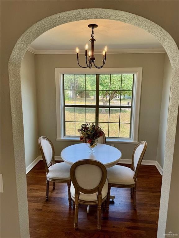 dining area featuring dark hardwood / wood-style flooring, an inviting chandelier, and a healthy amount of sunlight