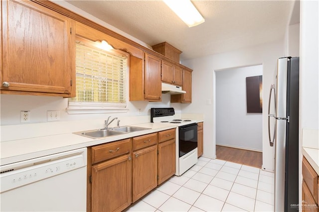 200 E Yuma Ave Unit 5, Mcallen, TX 78503 - kitchen featuring electric range, dishwasher, freestanding refrigerator, under cabinet range hood, and light countertops