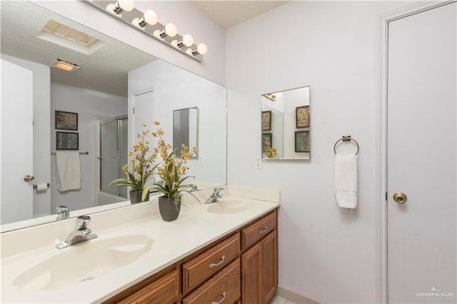 200 E Yuma Ave Unit 5, Mcallen, TX 78503 - full bath featuring double vanity, a shower with door, and a textured ceiling