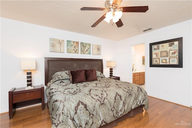 200 E Yuma Ave Unit 5, Mcallen, TX 78503 - bedroom with wood finished floors, a textured ceiling, connected bathroom, and ceiling fan