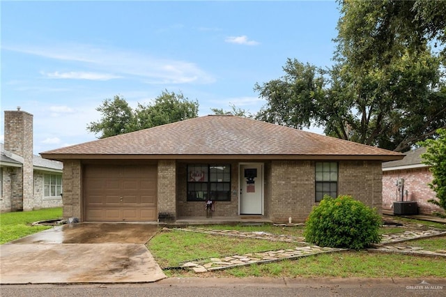 single story home featuring a shingled roof, brick siding, driveway, and an attached garage