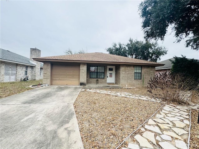 single story home with a garage, roof with shingles, concrete driveway, and brick siding