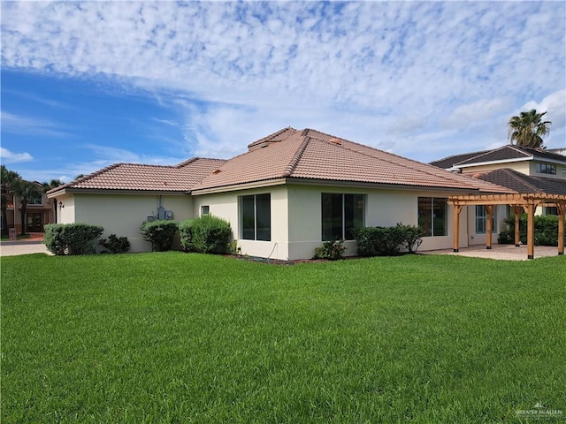 rear view of property featuring a yard and a patio