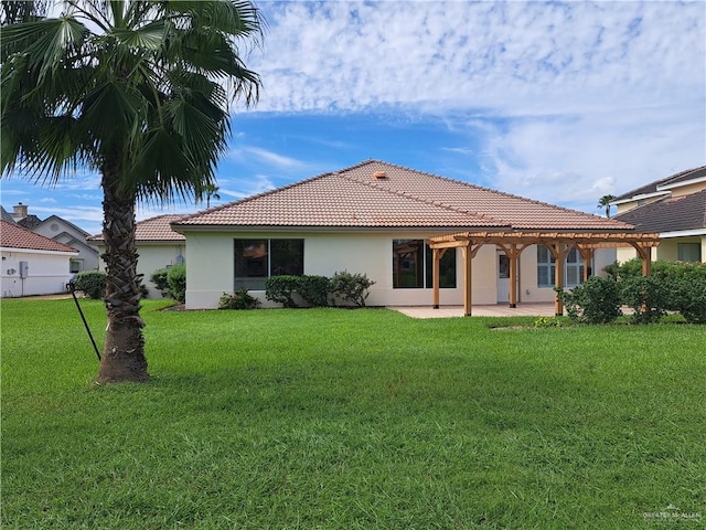 rear view of property with a patio and a lawn