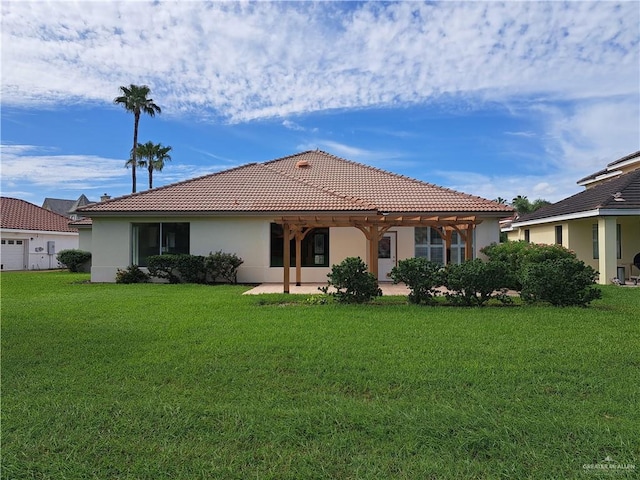 rear view of house with a yard and a patio