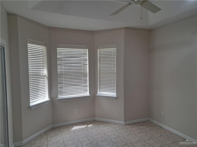 unfurnished room with light tile patterned flooring and ceiling fan