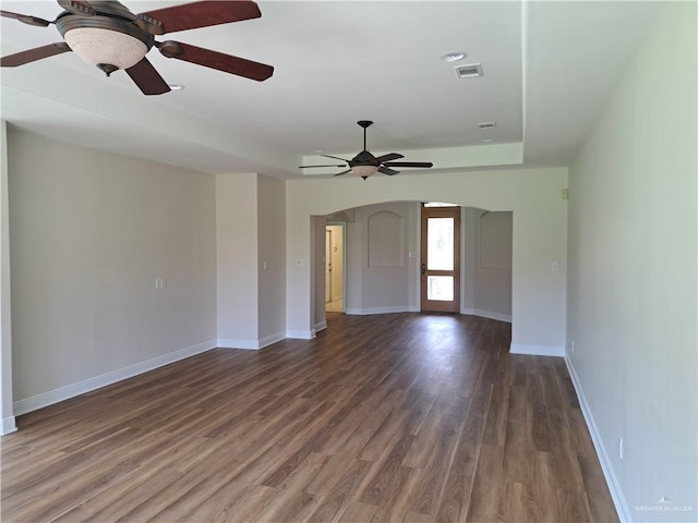 interior space with ceiling fan and dark hardwood / wood-style floors