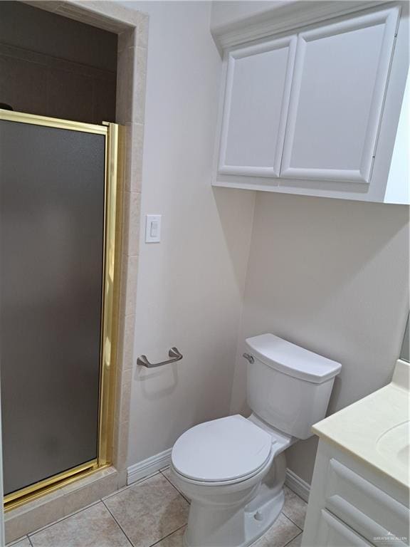 bathroom with vanity, a shower with shower door, tile patterned floors, and toilet