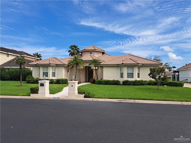 mediterranean / spanish-style home featuring a front lawn