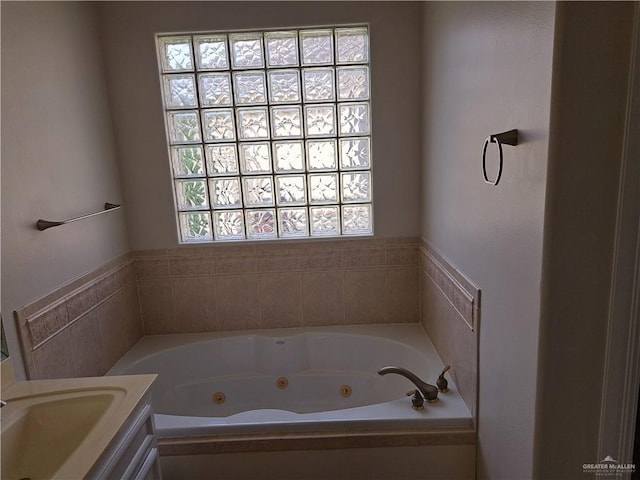 bathroom with vanity and a tub