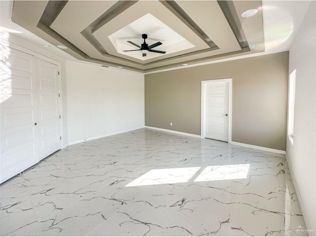 unfurnished bedroom featuring a raised ceiling