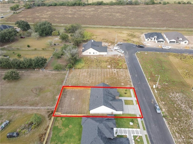 birds eye view of property with a rural view