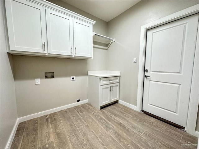 laundry room featuring cabinets, washer hookup, light hardwood / wood-style flooring, and electric dryer hookup