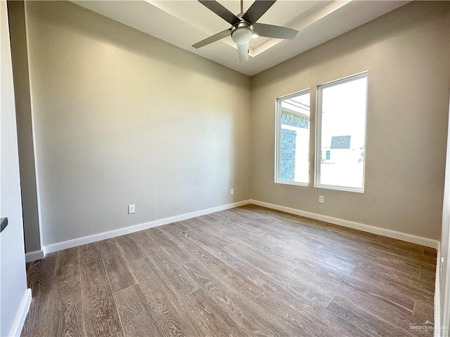 spare room with ceiling fan and hardwood / wood-style flooring