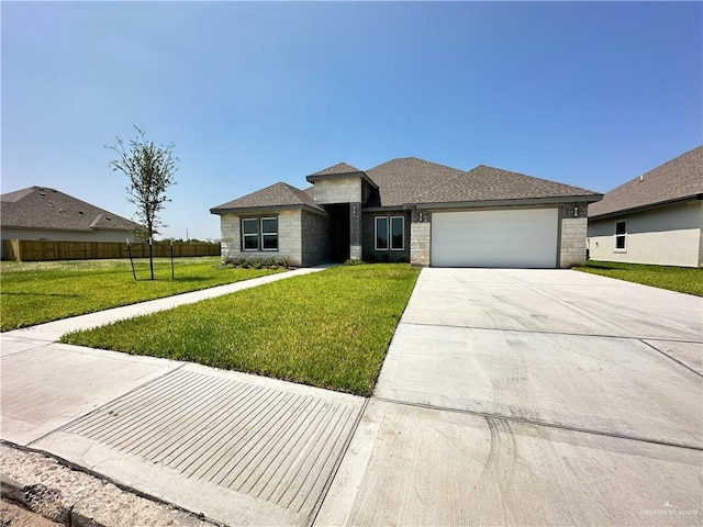 view of front facade featuring a garage and a front yard