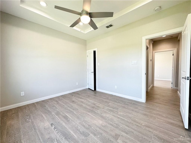 unfurnished bedroom with ceiling fan and light hardwood / wood-style flooring