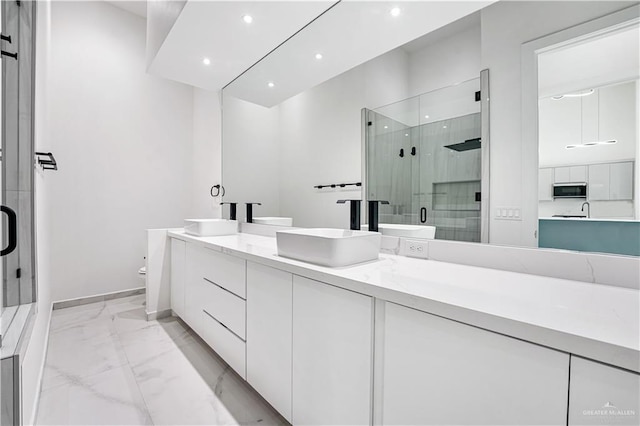 bathroom with vanity, toilet, and a shower with shower door