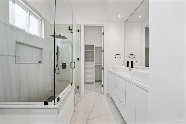 4713 S Brazos Rd S, Edinburg, TX 78542 - full bath featuring marble finish floors, a stall shower, double vanity, a walk in closet, and recessed lighting