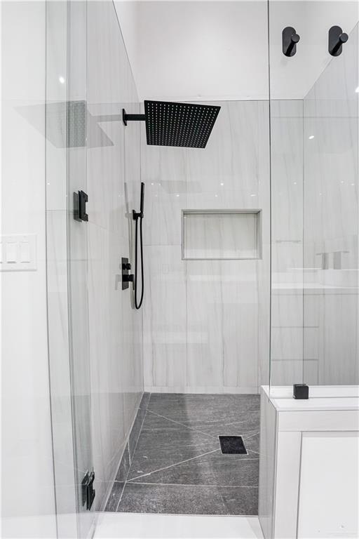 bathroom with a shower with shower door