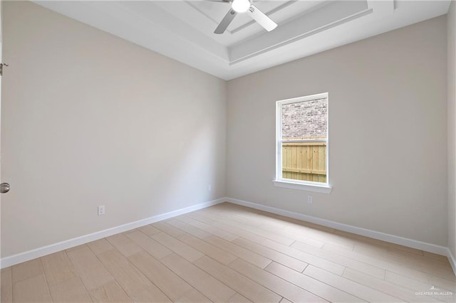 9110 N 25th St, Mcallen, TX 78504 - unfurnished room with a raised ceiling, a ceiling fan, light wood-type flooring, and baseboards