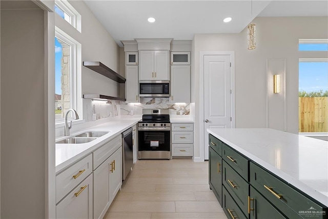 9110 N 25th St, Mcallen, TX 78504 - kitchen with stainless steel appliances, open shelves, a sink, light countertops, and green cabinetry