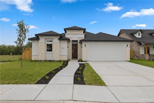 9110 N 25th St, Mcallen, TX 78504 - prairie-style house with an attached garage, stone siding, a front yard, concrete driveway, and stucco siding