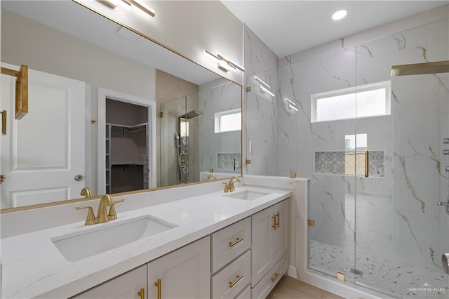 9110 N 25th St, Mcallen, TX 78504 - bathroom featuring a marble finish shower, healthy amount of natural light, double vanity, and a walk in closet