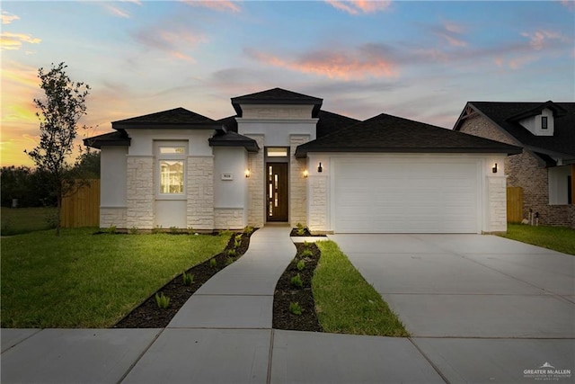 9110 N 25th St, Mcallen, TX 78504 - prairie-style home featuring an attached garage, stone siding, a front yard, driveway, and stucco siding