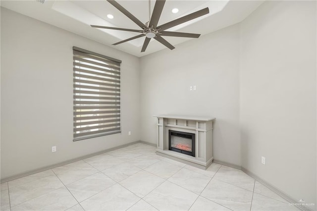 unfurnished living room featuring recessed lighting, baseboards, a ceiling fan, and a glass covered fireplace