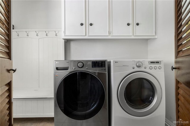 washroom featuring independent washer and dryer, cabinets, and tile patterned floors