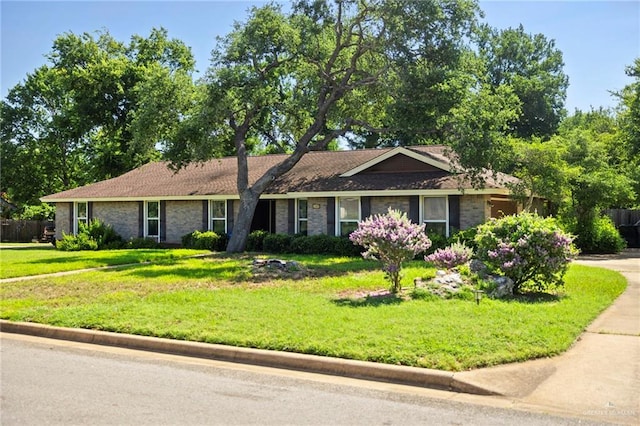 ranch-style home with a front lawn