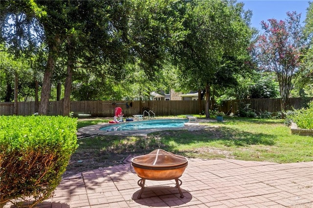 view of patio with a fenced in pool and a fire pit