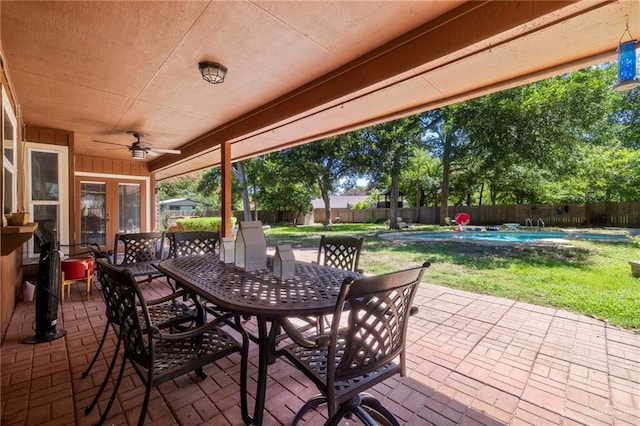 view of patio / terrace featuring a fenced in pool, ceiling fan, and french doors