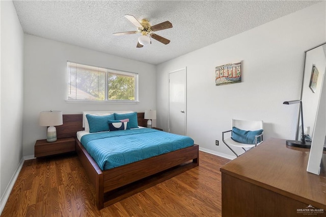 bedroom featuring ceiling fan, dark hardwood / wood-style floors, and a textured ceiling