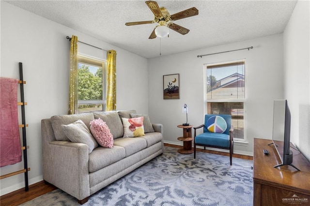 living room with hardwood / wood-style floors, a wealth of natural light, a textured ceiling, and ceiling fan