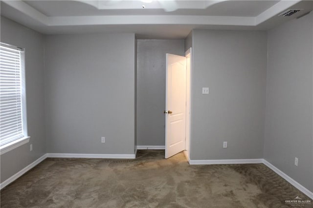 carpeted spare room with baseboards and visible vents