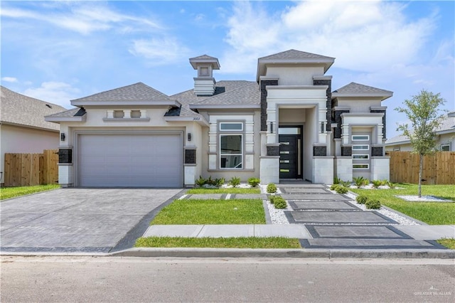 view of front of house with fence, driveway, stucco siding, and a shingled roof