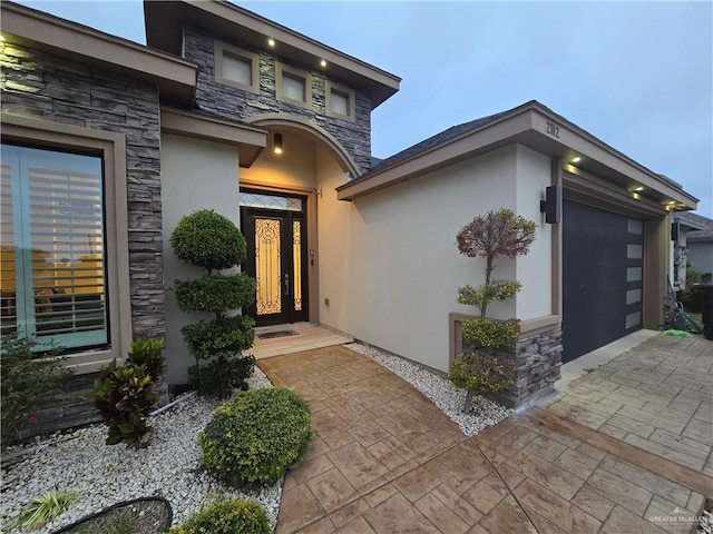 view of exterior entry featuring a garage