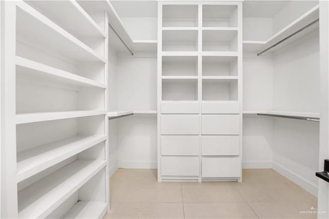 walk in closet with light tile patterned floors