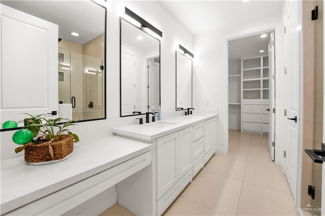 bathroom with tile patterned flooring, vanity, and a shower with shower door