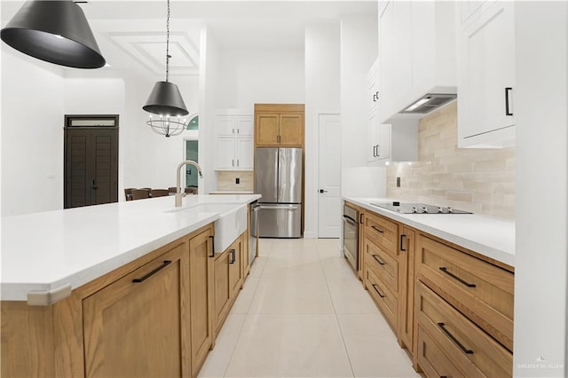 kitchen with white cabinetry, a large island, light tile patterned floors, and appliances with stainless steel finishes