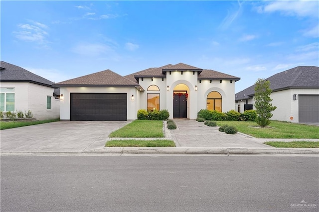 view of front of home featuring a garage and a front lawn